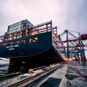 A large cargo ship docked at Gothenburg port with industrial cranes, Sweden.